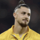 Radu Dragusin in action for Tottenham, facing an uncertain future as transfer rumors swirl around Inter Milan and Napoli